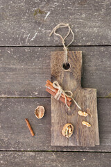Cinnamon sticks and walnut on a wooden board. High quality photo