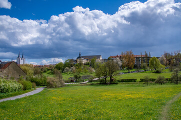Fototapeta na wymiar Landscape on the outskirts of Bamberg, Germany with spring meadow and impressive cloud play in the background