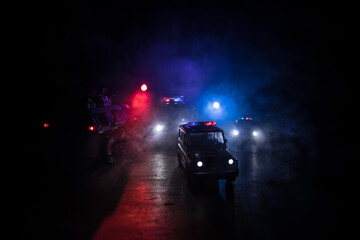 Police cars at night. Police car chasing a car at night with fog background. 911 Emergency response police car speeding to scene of crime. © zef art