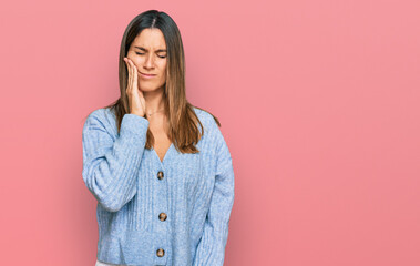 Young woman wearing casual clothes touching mouth with hand with painful expression because of toothache or dental illness on teeth. dentist