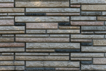 Wall of rectangular stones of different shapes and colors