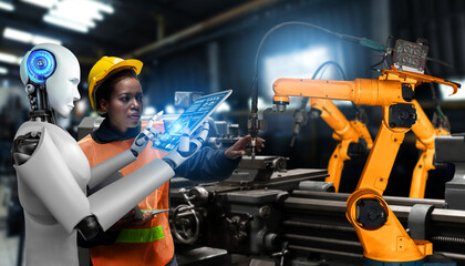 Mechanized industry robot and human worker working together in future factory . Concept of...