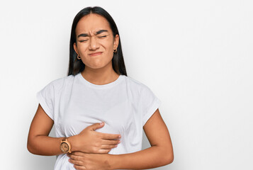 Obraz premium Young asian woman wearing casual white t shirt with hand on stomach because indigestion, painful illness feeling unwell. ache concept.
