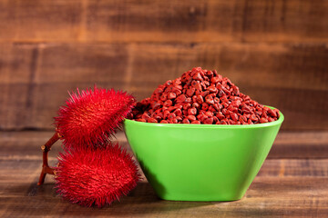 Organic achiote in the green bowl - Bixa orellana