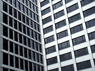 close up detail of tall high rose modern apartment buildings with white cladding and dark windows
