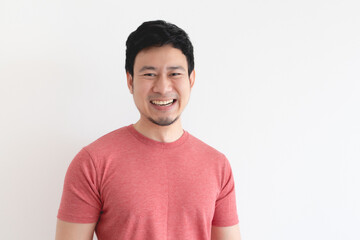 Enjoy and laughing face of Asian man in red t-shirt on isolated background.