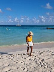 Palm Beach Aruba Caribbean, white long sandy beach with palm trees at Aruba Antilles, woman...
