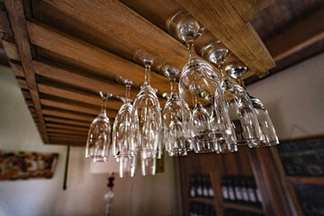 Close-up of wine glasses in a warm setting. Nice indoor with wooden furniture. Vineyard