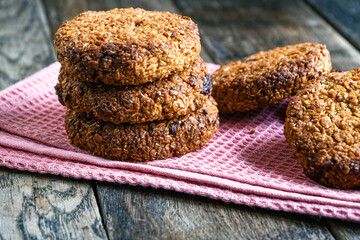 Homemade oatmeal cookies on a kitchen napkin on a wooden table. Cooking at home.