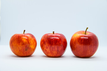 line of three red apples