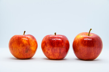 line of three red apples