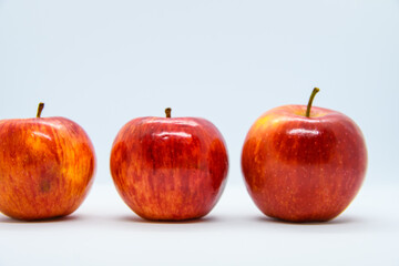line of three red apples