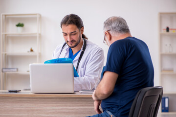 Old male patient visiting young male doctor