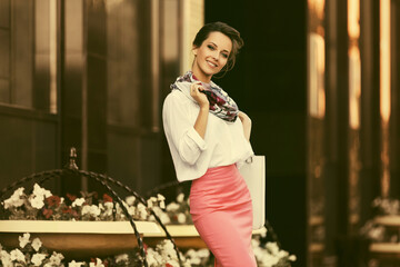 Young fashion business woman in white shirt and pencil skirt at office building