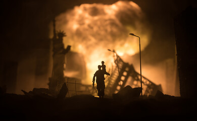 Silhouette of a man carrying injured girl from fire. Rescue savior concept. Military officer running out with woman from burned out city destroyed in war. Creative artwork decoration. Selective focus