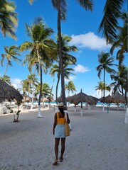 Palm Beach Aruba Caribbean, white long sandy beach with palm trees at Aruba Antilles, woman...