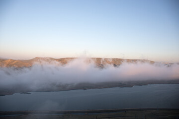 Beautiful clouds flying over the lake near mountains. Evening time shot over the clouds. Baku, Azerbaijan.