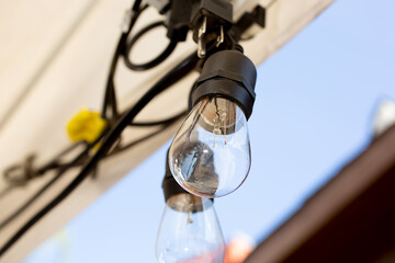 A closeup view of hanging vintage style lightbulbs.