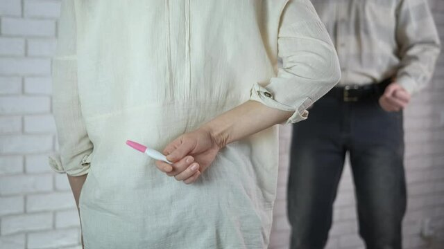 Family problem with pregnancy. A husband shouting ather wife with a pregnant test in her hands.