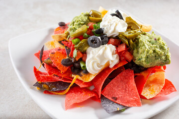 A view of a plate of colorful nachos.