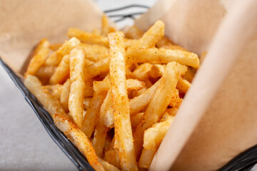 A closeup view of a basket of french fries.