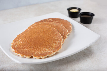 A view of a plate of plain pancakes.