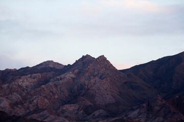 Naklejka premium The Andes mountain range at sunset. Beautiful purple hills rocky texture background. 