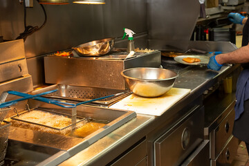 A view of the deep fryer station of a restaurant kitchen.