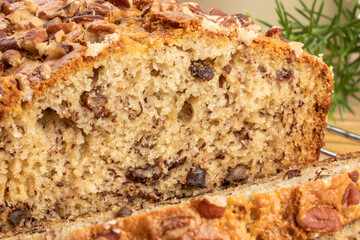 A close up macro view of texture of a loaf of banana bread with pecan pieces baked in