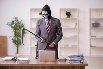 Devil businessman employee sitting at workplace