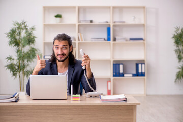 Young male employee working in the office