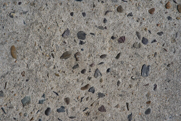 Cement texture with small stones inlaid. Gray color. Background for design