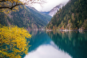 The Perl of Jiuzhaigou __ Long Lake is the biggest & deepest lake in Jiuzhaigou. On clear days its dark wooded hillsides & blue waters are viewed against the backdrop of the 5000m/16.400ft snow capped