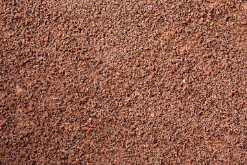 A top down view of a background of small chocolate shavings as a cake topping.