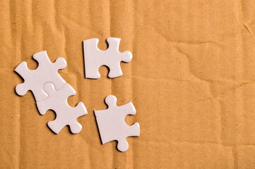 White jigsaw puzzle on cork board with copy space. Conceptual image