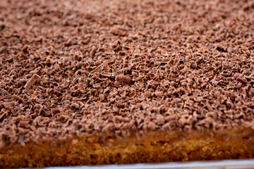 A closeup view of a background of small chocolate shavings as a cake topping.