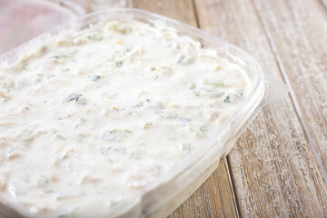 A view of a container of Armenian chicken salad.