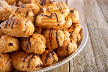A view of a tray of mini eclair pastries.