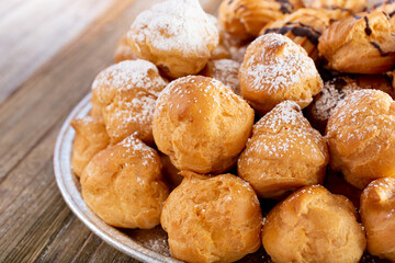 A closeup view of a tray of French cream puffs.