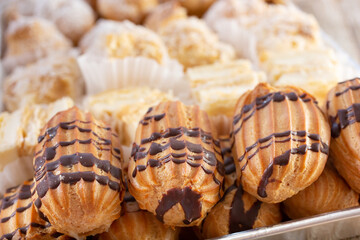 A view of a tray of mini eclair pastries.