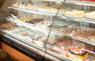 A view of a display of assorted European pastries, seen inside a bakery shop.
