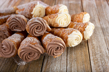 A view of a tray of chocolate and vanilla cone pastries.