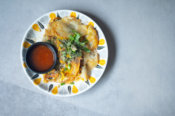 Pan fried crispy oysters with bean sprout and egg served with sauce