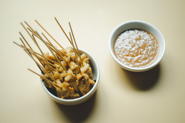 Grilled chicken skewers served with peanut dipping sauce