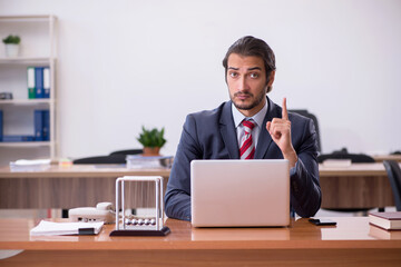 Young man businessman employee sitting in the office