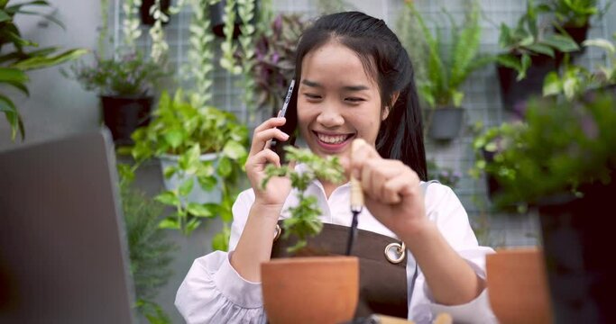 Woman talking with phone about sell plant with customer