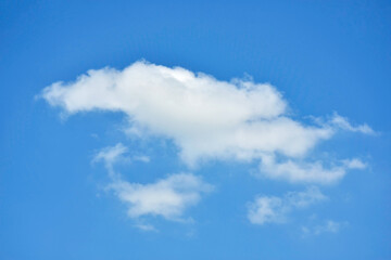 Beautiful cumulus clouds against the blue daytime sky.