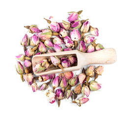 top view of wood scoop on dried rose buds on white