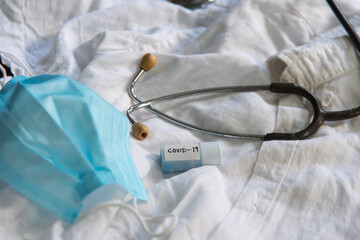 Healthcare medical equipment face mask, stethoscope background. Close up, selective focus.