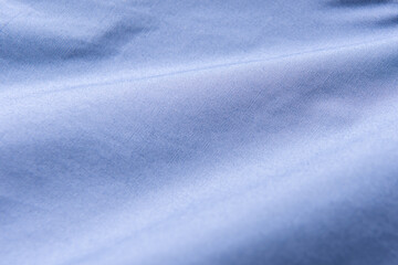 Closeup of rippled blue silk fabric, Blue fabric texture background,